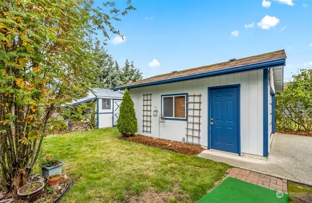 Detached garage with double rool up door and side access.