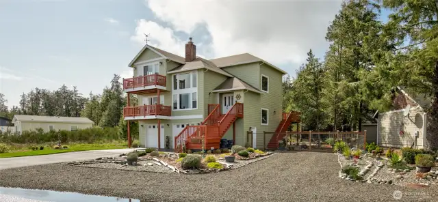 Fully landscaped all around, with paved driveway and RV parking with hookups.