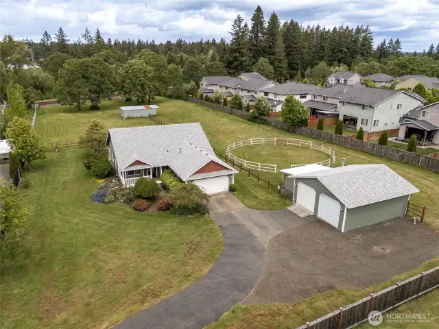 From curb appeal to corral, this shot’s got it all. Blooming landscape up front, serious parking potential by the shop, and equine-ready trees stretching out in the distance. The only thing missing? You.