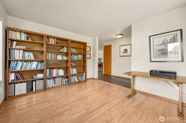 This space balances function and flair effortlessly. Warm wood trim complements durable laminate floors, while the slate tile hallway adds a subtle touch of sophistication. It’s a layout designed for smooth transitions.