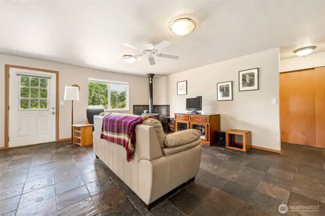 Easy backyard access thru the windowed back door, and that wood stove in the corner? Untouched by the current owners, but full of cozy potential, so imagine curling up with a good book or your favorite show.