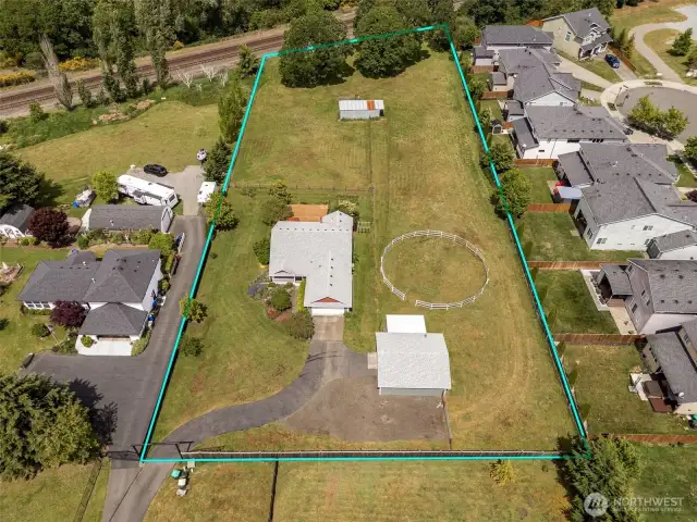 Front and back perks: a welcoming view up front, a barn holding down the back, and greenspace buffer near rails just beyond your backyard. Privacy and possibilities? Check.