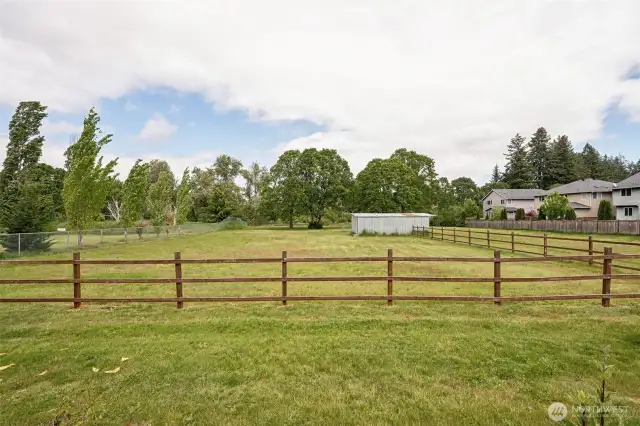 Sprawling space with wood fencing designed for horses or just serious outdoor vibes. Boarding area and barn/shop add function, while the wooded land behind offers the kind of privacy every dream property deserves.