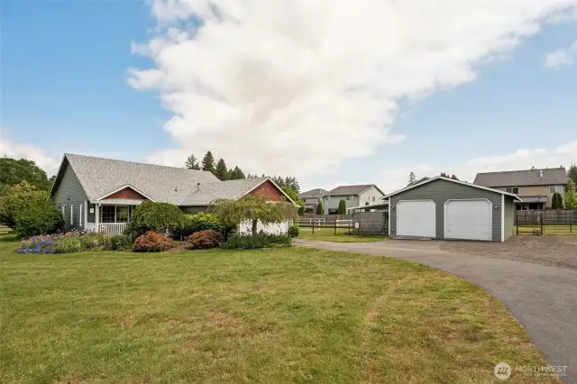 Long driveway, big garage with included freezer, and an even bigger shop...think 7' garage doors plus giant 9'x9' shop doors. Riding mower is included the deal, and parking? Plenty for all your toys, horse trailers, and all your family and friend’s vehicles.