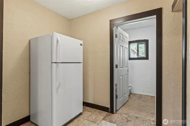 kitchen offers direct access to a spacious laundry room—ready for your finishing touches and perfect for customizing to your needs.