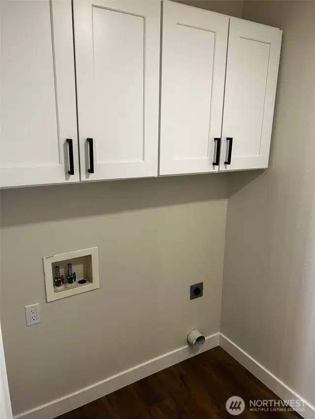Full sized laundry room with cabinets