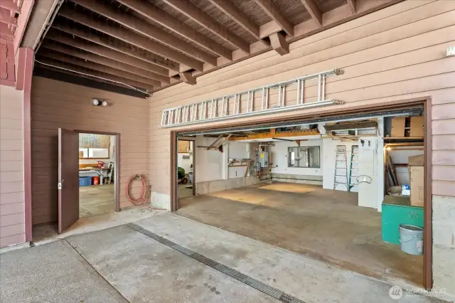 This is the second of 3 garages.  It features 2 parking spaces [as long as one is a mini-cooper size or Harley D Cycle etc, ... also tons of built-in shelving plus a storage rack above with approximately 200 SF of room for much more. Plug-in your welder! electrical sub panels are installed.