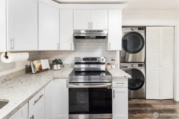 Sleek stainless range with subway tile backsplash, just steps from the back porch for easy indoor-outdoor dining.