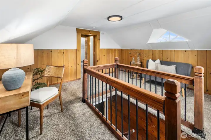 A versatile loft landing—ideal as a reading nook, desk space, or cozy lounge.
