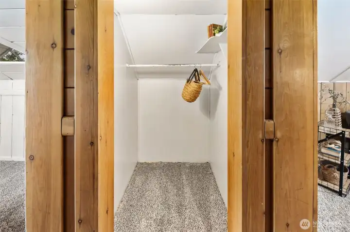 Deep upstairs closet provides practical storage while keeping the room clutter-free.