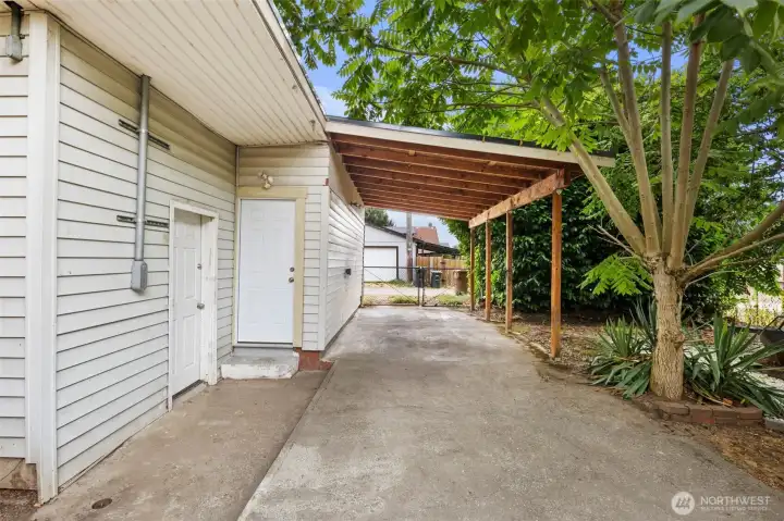 Convenient carport provides covered parking and easy access to the backyard and home.