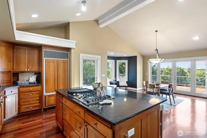 At the heart of the home is the tastefully designed kitchen, where Brazilian Cherry cabinetry pairs elegantly with gleaming granite countertops.