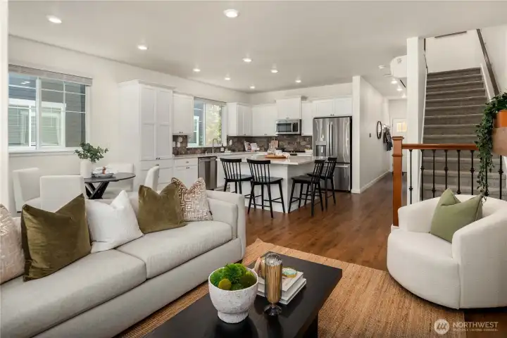 The living room is flanked by the open rail stairwell leading up to 3 bedrooms. (a 4th bedroom is down)