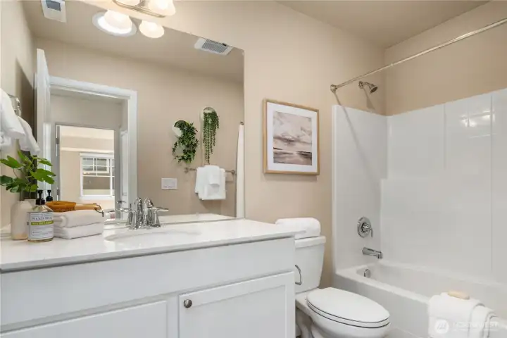 The main bath located upstairs is spacious and clean.