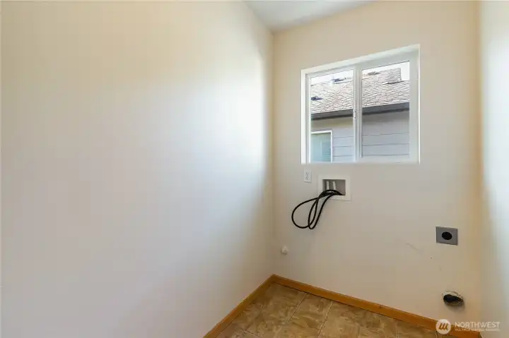 Upstairs laundry room conveniently located between bedrooms