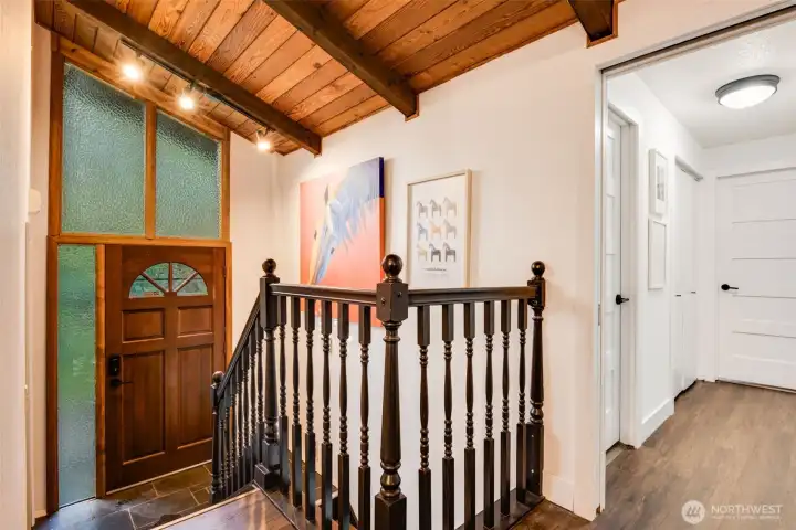 Gorgeous entry with coat closet and the start of the beautiful wood ceilings
