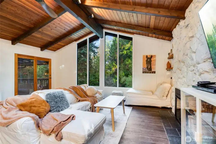 Cozy living space with fireplace and access to the private deck