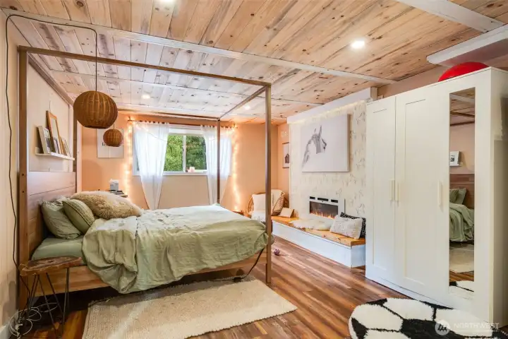 Cozy fireplace and sitting area in this captivating second primary on the lower level