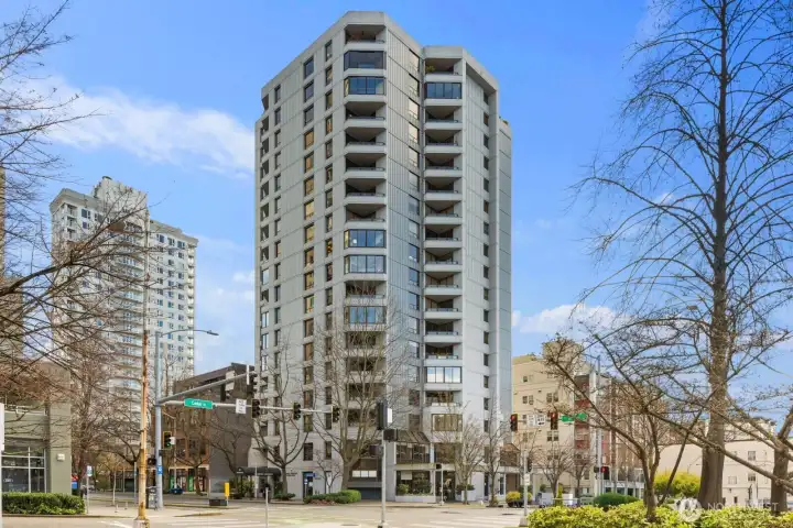 Seattle condo high-rise located at the corner of 2nd Avenue and Cedar Street in Belltown featuring a modern tower design with private balconies and walkable city surroundings.