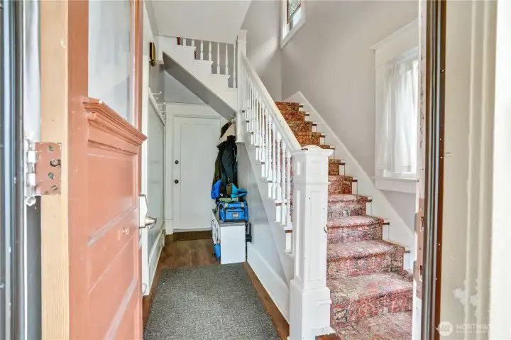 Main entrance. Straight ahead is the door to unit A. Up the stairs is unit B.