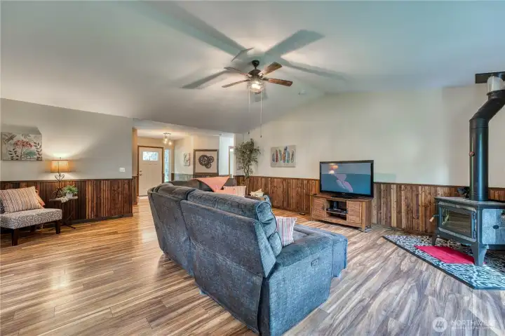 Custom wainscotting and newer free standing stove with soap stone surround all complemented by the beautufil hardsurface flooring.