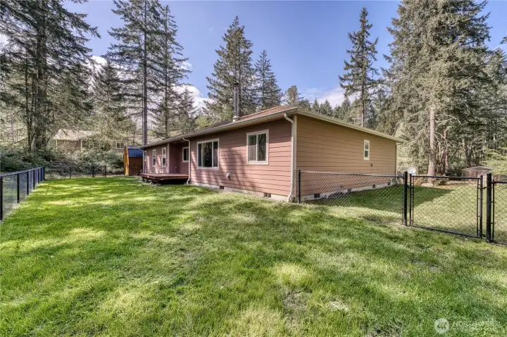 Backyard with a section of fencing allowing the animals to roam without wandering off.