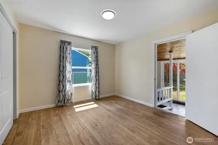 Bedroom 2 without the furnishings. This bedroom is located on the side with a door going into the backyard sliding glass doors and the basement.