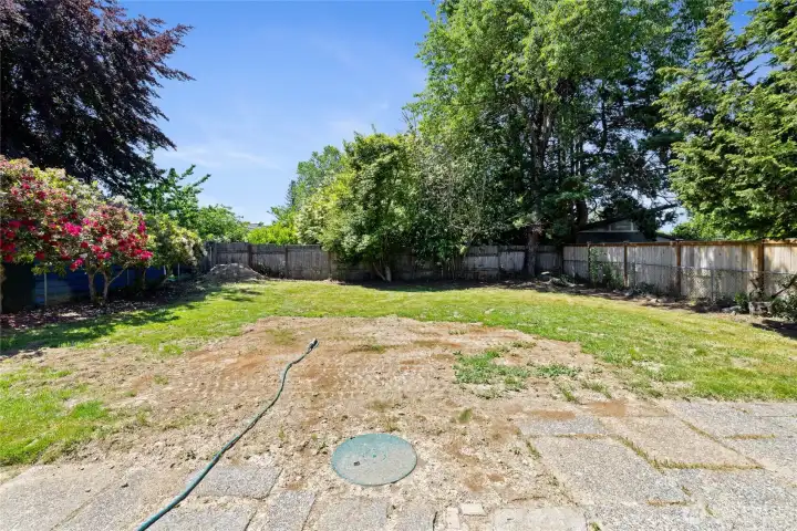 This area is the location of the septic tank. The house has a new septic tank and new seed put in for grass.. it will see fruition in the coming months.