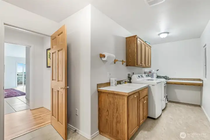 The laundry room has a sink and folding table.