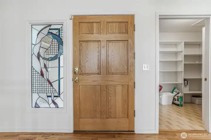 Custom stained glass by a world famous artist that lives right here on Camano adorns the front door.  The home also features an oversized pantry.