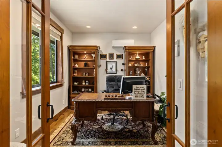 Den/office with french doors is located just off the entry.