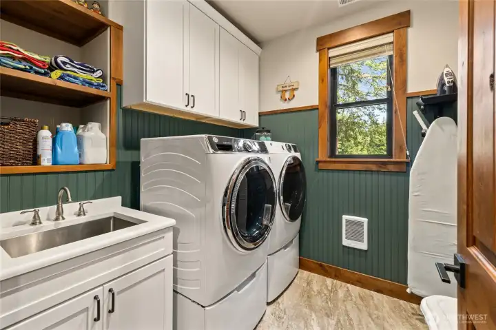 Laundry room with storage area.