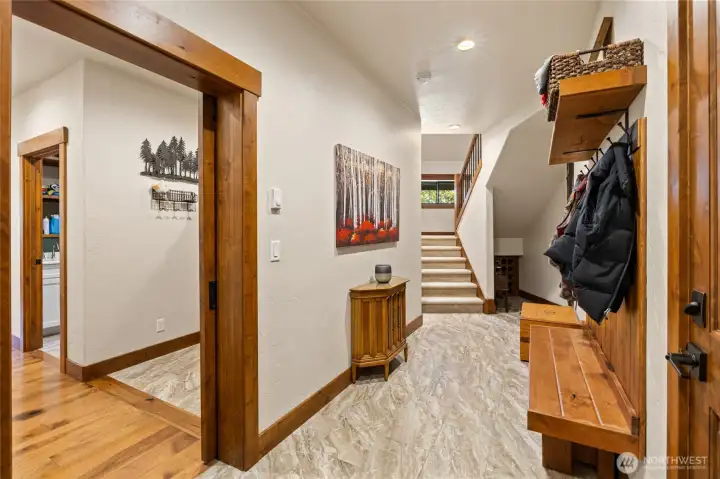 Entry area from the garage leads to main living space and bonus area upstairs.