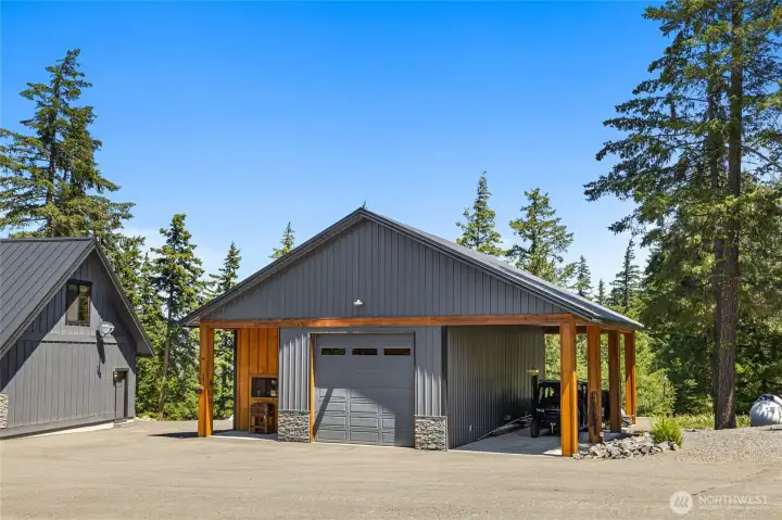 Detached shop with covered porch and carport for extra covered parking.
