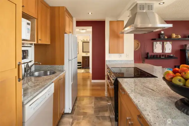 Efficient Kitchen with slab granite countertops and lots of storage.