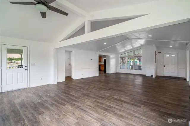 Great room with vaulted ceiling has ample natural light