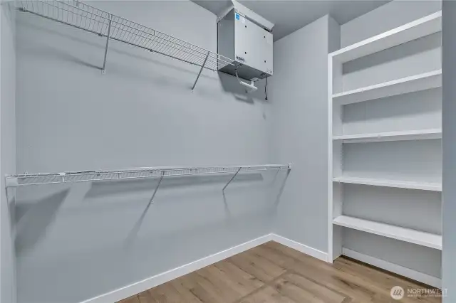 Primary Walk-In Closet with lots of hanging and shelf space.