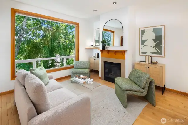 Gather in front of the gas fireplace for easy conversation.  Hardwood floors, tall ceilings, large picture windows that bring the outside in.