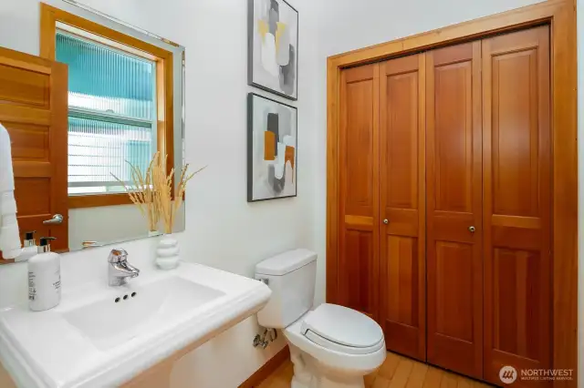 Main floor powder room with large storage closet