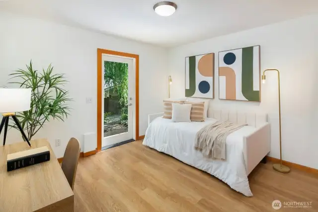 Located on the lower level the guest bedroom has a large closet with built-in shelving, room for a desk or comfy reading chair and access to the back yard.
