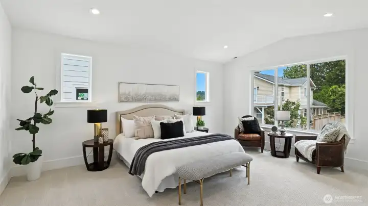 Primary Suite: Upstairs, the vaulted-ceiling primary suite captures serene peekaboo views of Lake Washington — a reminder of the home’s coveted location. The room’s clean lines, soft palette, and abundant natural light create a tranquil environment designed for rest and renewal.