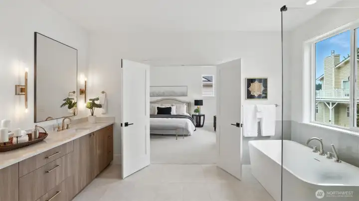 Spa-Inspired Bath: A statement in calm sophistication, the primary bath combines timeless design with modern indulgence. Dual vanities, brass-accent lighting, and a deep soaking tub invite relaxation, while the walk-in glass shower and broad picture window deliver a true spa-day atmosphere at home.