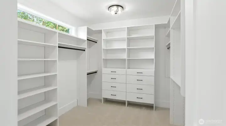 Two Custom Walk-In Closets in the Primary Suite:  One of two primary suite closets - Generous built-ins, open shelving, and tailored drawer systems make these closets as functional as they are beautiful. Bright, organized, and spacious, it’s a boutique-style dressing room that completes the suite’s sense of elevated daily living.