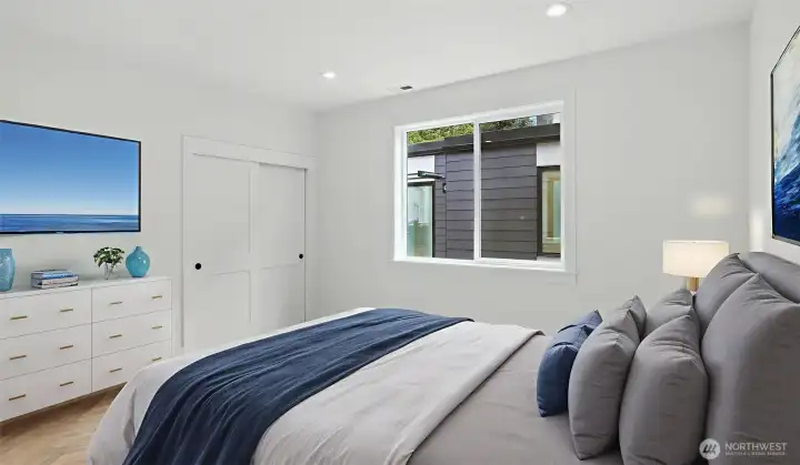 Each secondary bedroom continues the home’s bright, serene aesthetic, pairing clean architectural lines with soft textures and spacious closets — a thoughtful balance of comfort and design continuity.