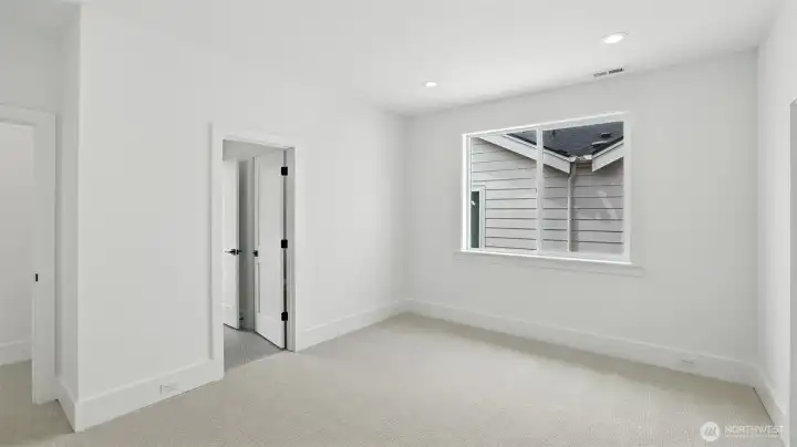 Each secondary bedroom continues the home’s bright, serene aesthetic, pairing clean architectural lines with soft textures and spacious closets — a thoughtful balance of comfort and design continuity.