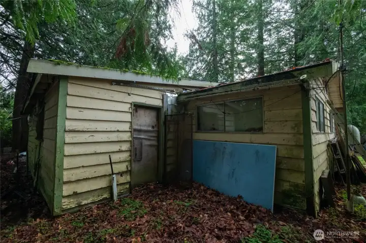 Back of home. The existing structures may be removed or reworked to suit your plans. Property purchased strictly as-is.