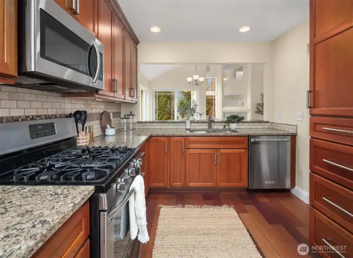 Kitchen looking over eating bar out towards living space.