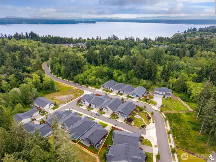 One of the reasons Jubilee has become such a beloved community is its connection to the surrounding natural beauty, and this view tells that story perfectly. Looking out toward Nisqually Reach, you can see just how close you are to the shoreline where residents enjoy access to a shared saltwater beach reached by miles of community trails and sidewalks. Nearby destinations include Billy Frank Jr. Nisqually National Wildlife Refuge and Tolmie State Park, creating endless opportunities to enjoy the outdoors without traveling far from home. The best part might be that all this peaceful scenery exists just minutes from everyday conveniences, with Costco Wholesale, coffee shops, dining, healthcare and shopping all less than 10 minutes away.