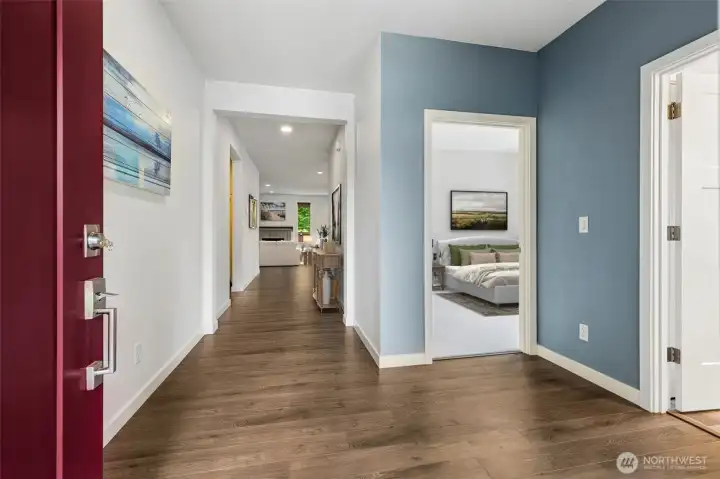Standing at the front door, you can immediately appreciate how thoughtfully this floorplan was designed. To the left, the hallway gently draws you toward the open-concept great room, kitchen and dining areas that serve as the heart of the home. To the right, you'll find the guest wing, including the two secondary bedrooms and full bathroom, creating a wonderful separation between guest spaces and the private primary suite located elsewhere in the home. This layout gives visitors a comfortable place to stay while allowing everyone a little extra privacy.