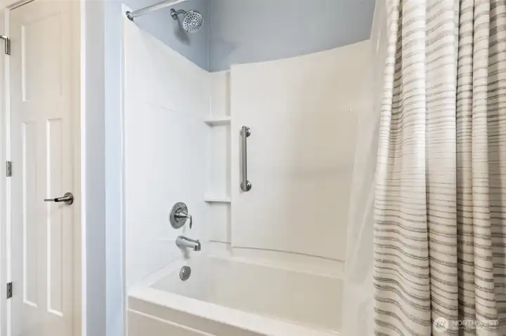 The main bathroom was designed with practicality in mind while still feeling bright and welcoming. A full tub and shower combination creates options for both quick mornings and relaxing evenings, while attractive stone style vinyl flooring offers the waterproof durability buyers love. Storage is always important, and the linen closet conveniently located within the bathroom helps keep everything organized and within easy reach. Another thoughtful feature is the separate toilet room, complete with a brand-new toilet, creating additional privacy and making the space much more functional when guests are visiting or multiple people are sharing the bathroom.